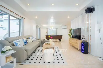 Spacious modern living room with pool table and stylish decor