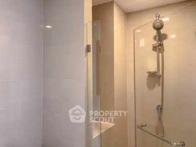 Modern bathroom with sleek shower design and neutral tiles