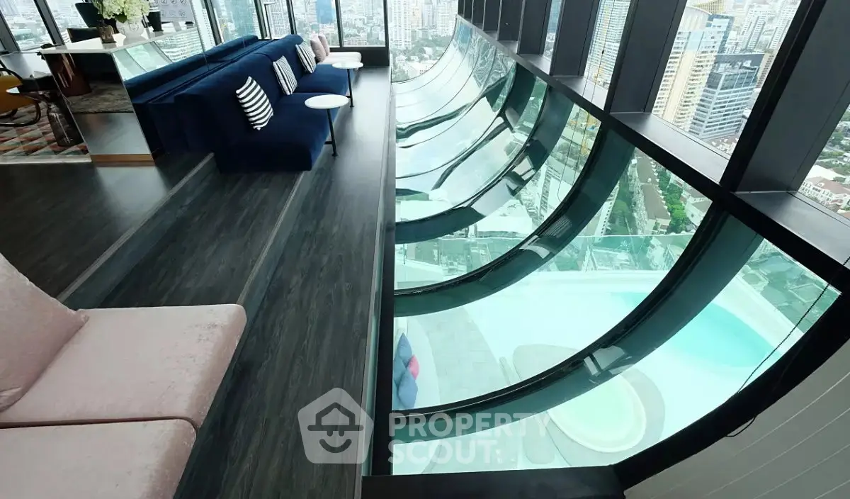 Luxurious high-rise apartment with stunning curved glass windows and breathtaking city views.
