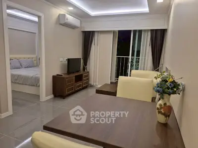 Modern living room with elegant decor and open view to bedroom