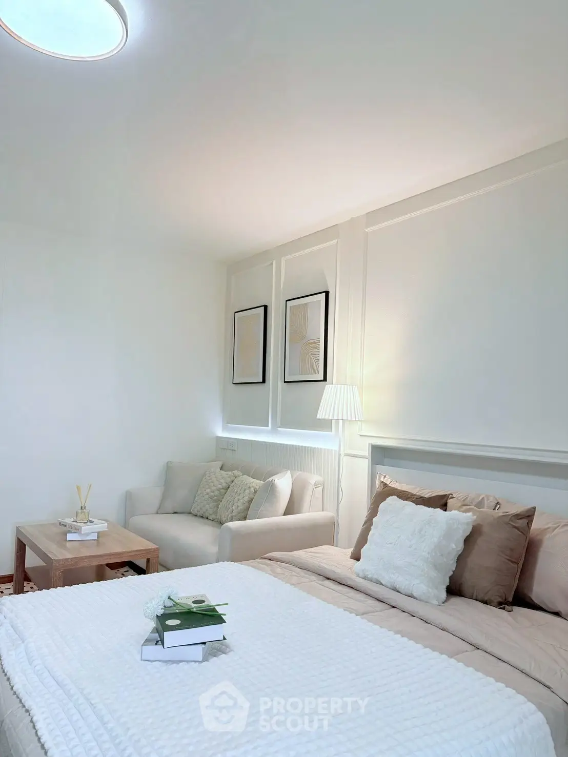 Cozy bedroom with elegant decor and soft lighting, featuring a comfortable bed and stylish seating area.