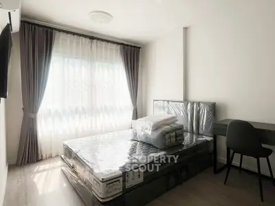 Bright and modern bedroom with large window and sleek furnishings