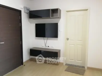 Modern living room with wall-mounted TV and sleek storage units