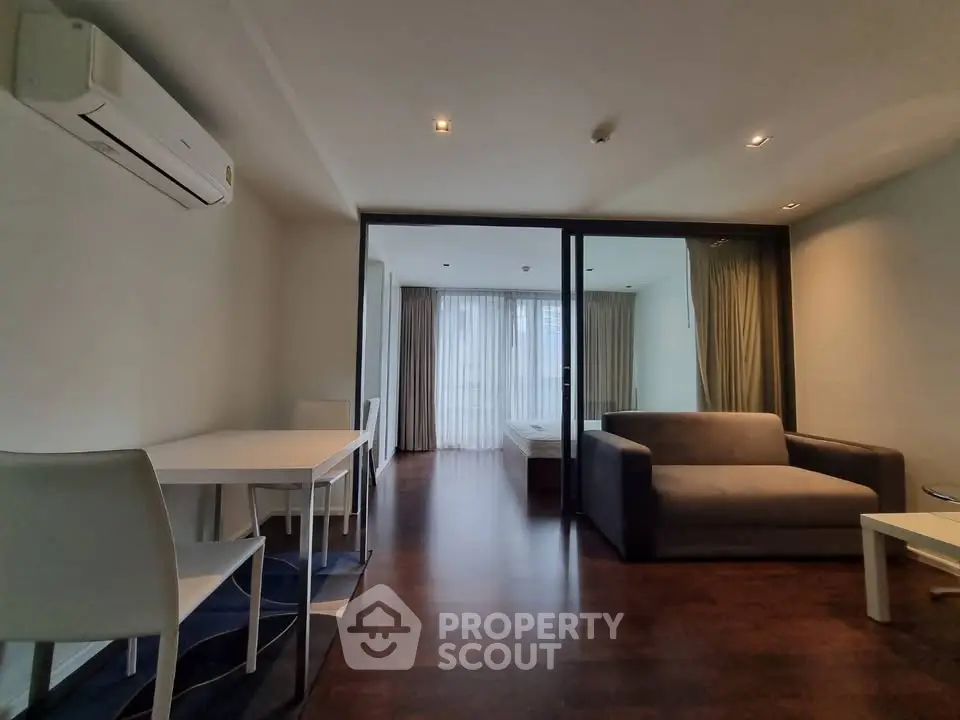 Modern living room with sleek furniture and large windows for natural light.