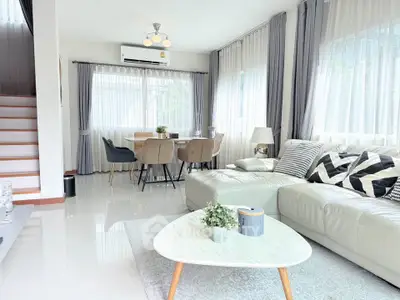 Spacious modern living room with elegant decor and ample natural light, perfect for relaxation and entertaining.