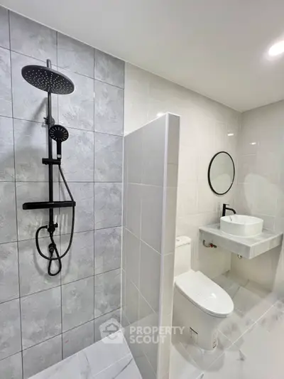 Modern bathroom with sleek shower and stylish vanity in contemporary design.