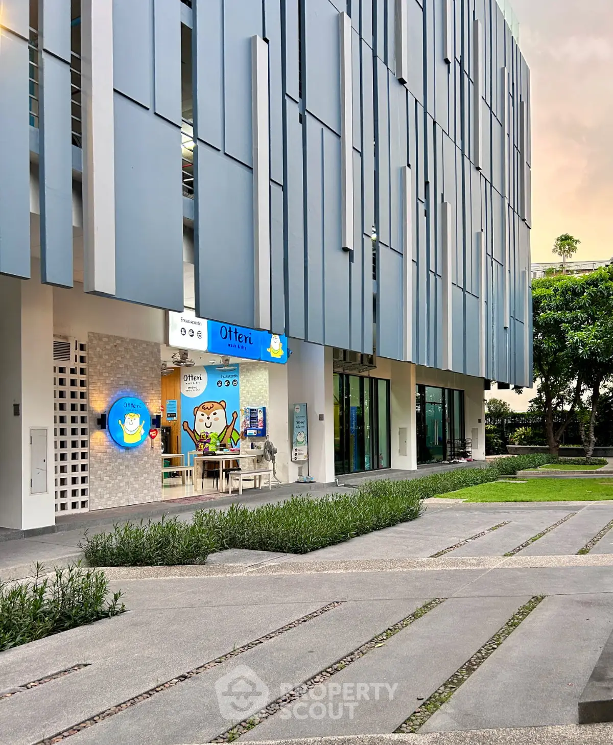 Modern building exterior with unique facade and landscaped walkway
