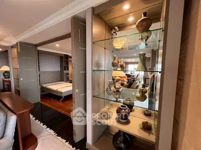 Luxurious living room with elegant decor and spacious layout, featuring stylish shelving and ambient lighting.