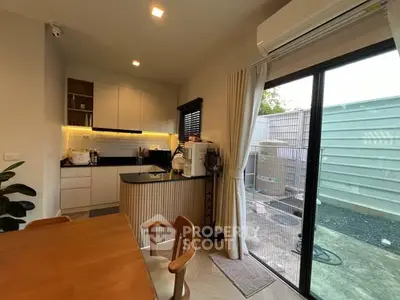 Cozy kitchen with open layout and sliding glass door to patio