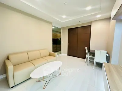 Modern living room with beige sofa and sleek dining area