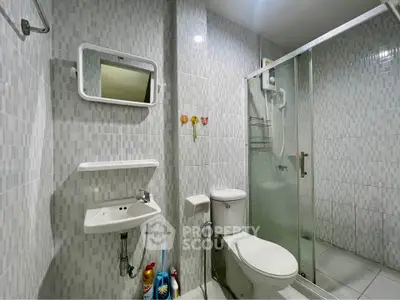 Modern bathroom with glass shower and sleek white fixtures