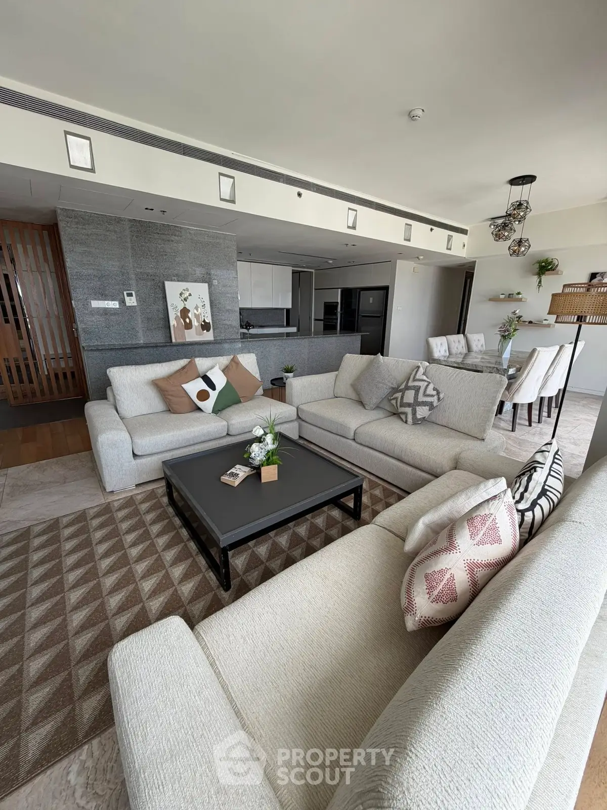 Spacious modern living room with elegant decor and open kitchen layout