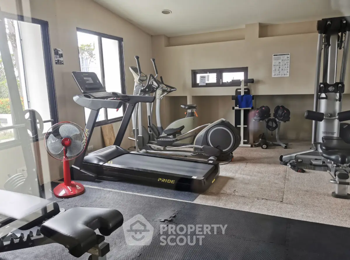 Modern gym with state-of-the-art fitness equipment and natural light, perfect for an active lifestyle.