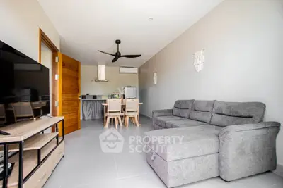 Modern living room with gray sectional sofa and open kitchen layout