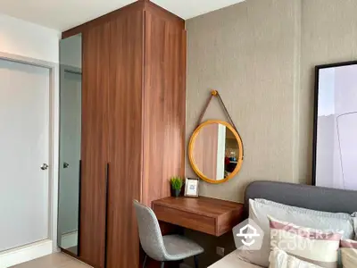 Cozy bedroom with modern wooden wardrobe, stylish wall-mounted desk and mirror, complemented by soft lighting and tasteful decor.