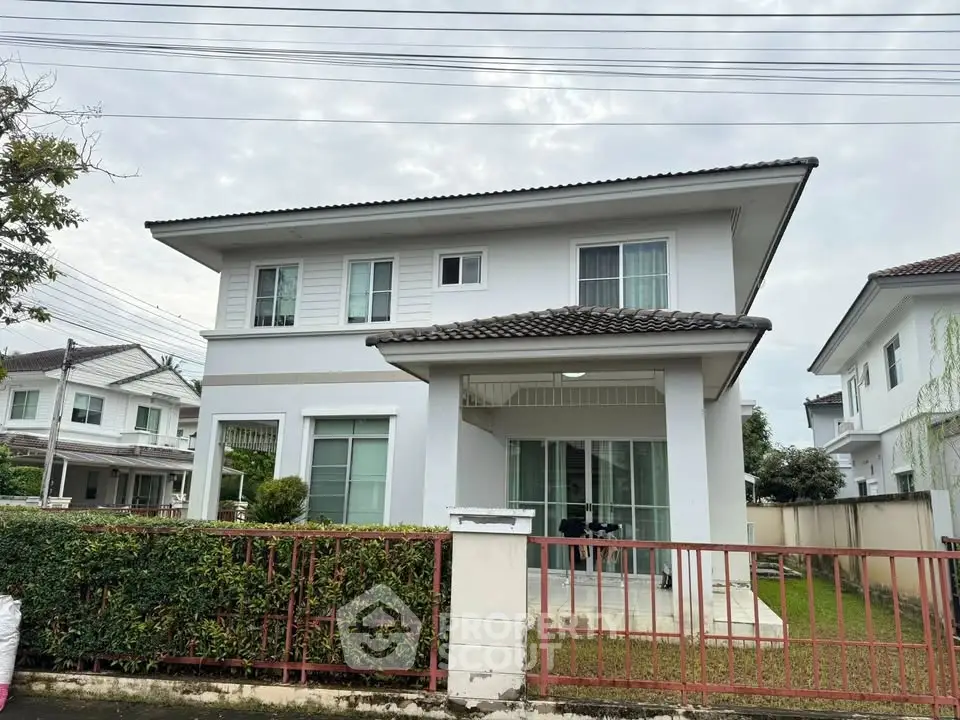 Charming two-story house with modern design and lush garden in a serene neighborhood.