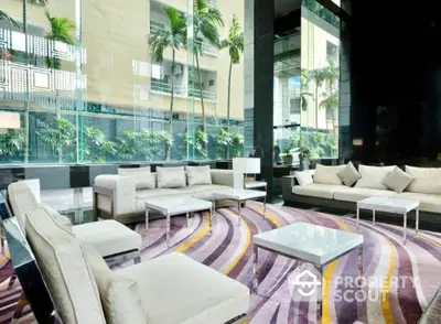 Luxurious modern living room with elegant sofas and vibrant carpet in high-rise building