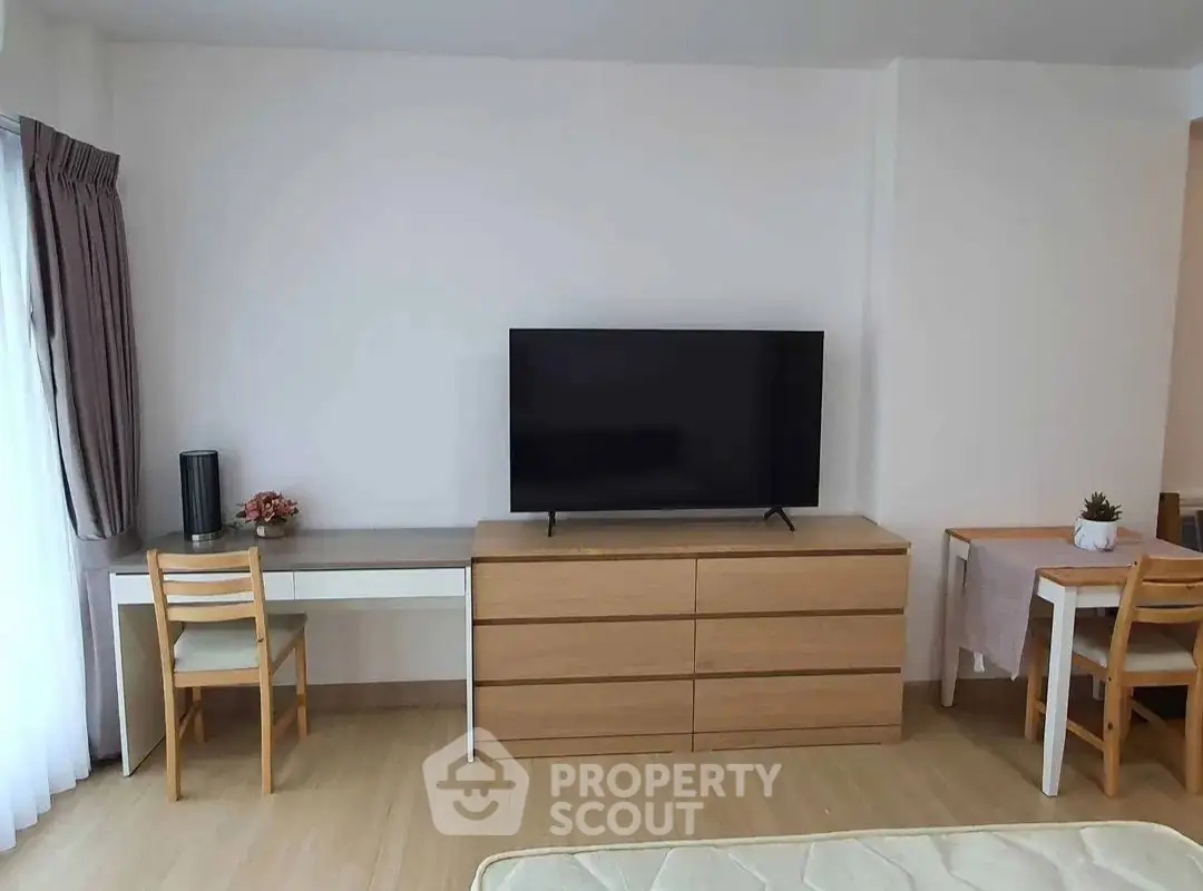 Modern living room with sleek TV setup and stylish furniture, perfect for contemporary living.