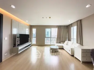 Spacious modern living room with panoramic city views and elegant furnishings.