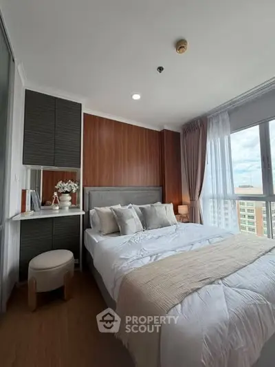 Modern bedroom with large window and stylish decor in high-rise apartment