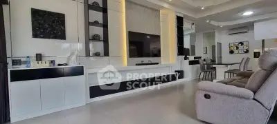 Spacious modern living room with sleek built-in entertainment center and cozy seating.