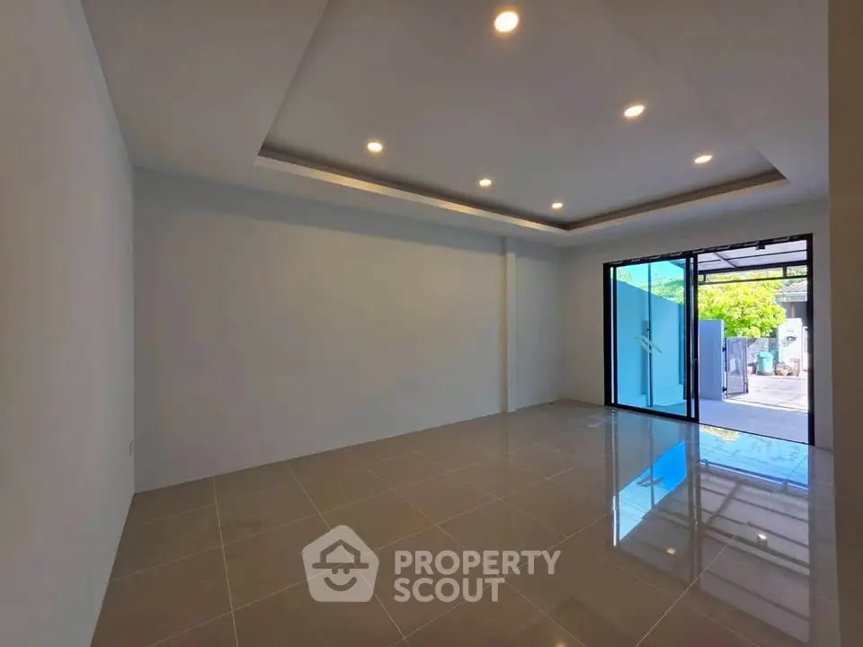 Spacious modern room with large windows and recessed lighting, perfect for versatile use.