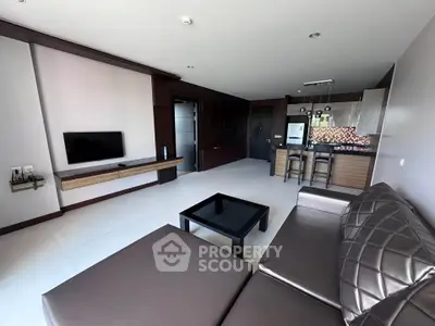 Modern living room with sleek furniture and open kitchen layout in a stylish apartment.