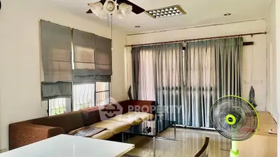 Spacious living room with modern furniture and large windows for natural light.