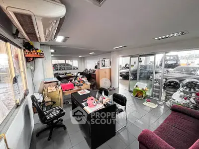 Spacious office space with modern furniture and large windows, ideal for business operations.
