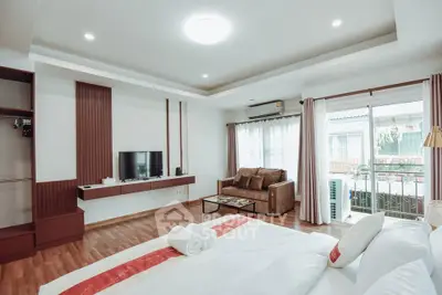 Spacious bedroom with modern decor and balcony access
