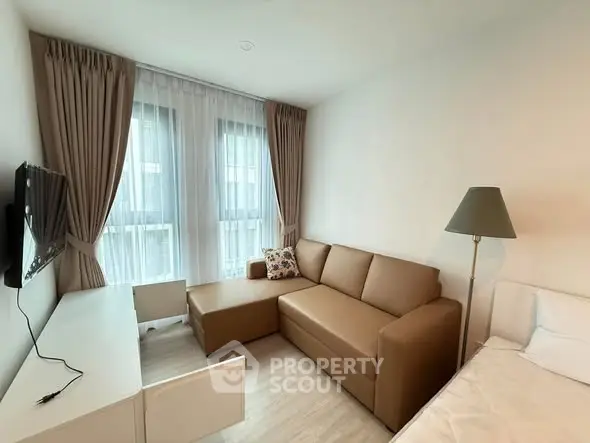 Cozy living room with modern sofa and natural light in stylish apartment