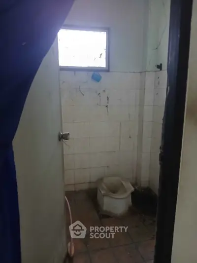 Basic bathroom with simple fixtures and tiled walls, ideal for renovation or remodeling projects.