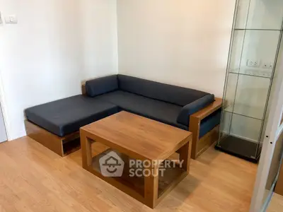 Modern living room with wooden furniture and glass display cabinet