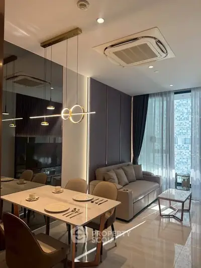 Modern living room with elegant dining area and stylish lighting in a high-rise apartment.