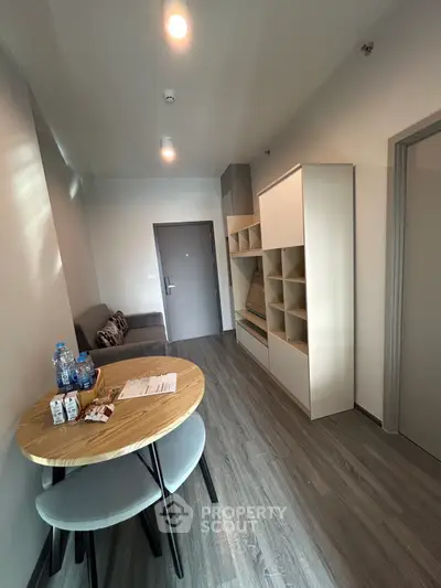 Modern apartment interior with cozy living area and stylish dining setup.