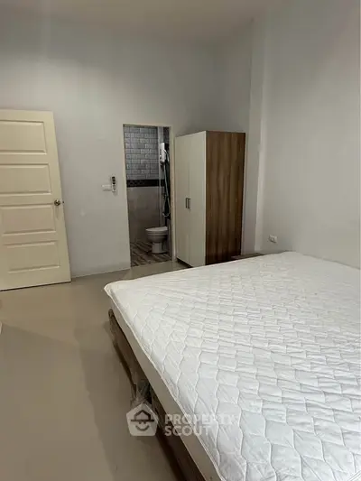 Modern bedroom with ensuite bathroom and minimalist decor