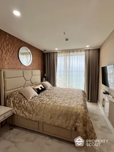 Luxurious bedroom with elegant decor and stunning sea view, featuring plush bedding and modern furnishings.