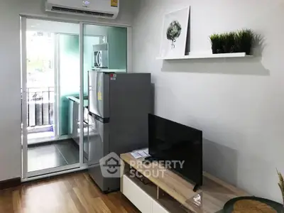 Modern living room with balcony, featuring sleek furniture and appliances for a comfortable lifestyle.