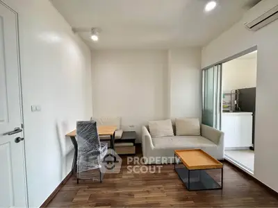 Modern living room with cozy sofa and dining area in open layout apartment