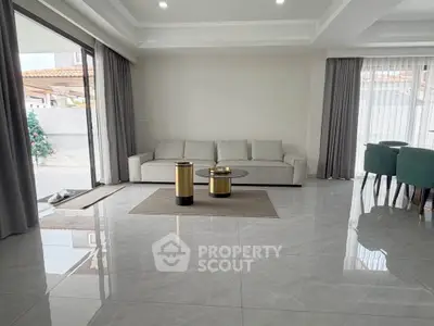 Spacious modern living room with sleek furniture and large windows for natural light.