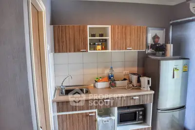 Modern kitchen with sleek cabinetry and stainless steel appliances in a compact layout.