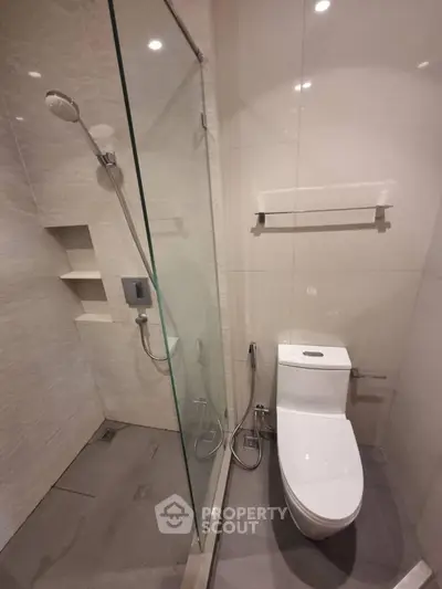 Modern bathroom with glass shower and sleek toilet design