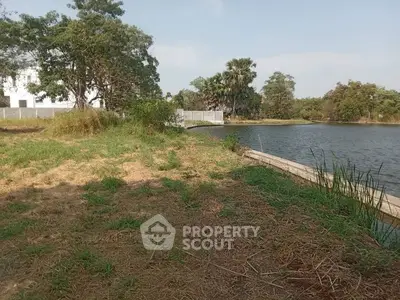 Scenic waterfront land with lush greenery and serene views, perfect for development or investment.