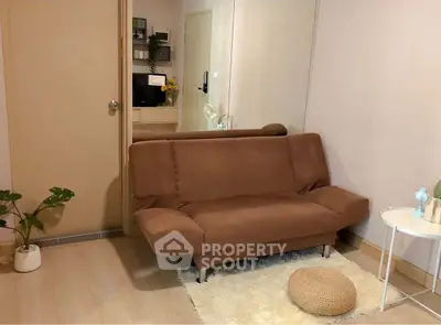Cozy living room with brown sofa and modern decor in a stylish apartment.