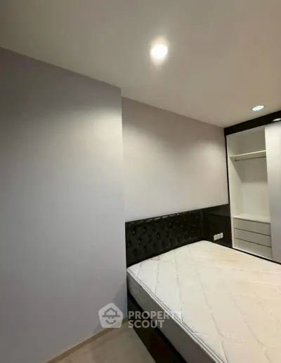 Modern bedroom with sleek design and built-in wardrobe, perfect for urban living.