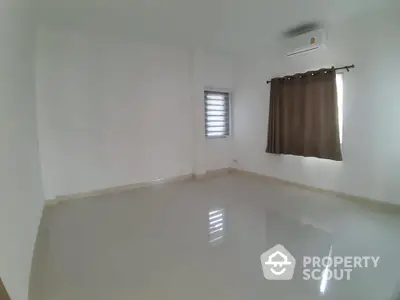 Spacious unfurnished room with air conditioning and tiled flooring