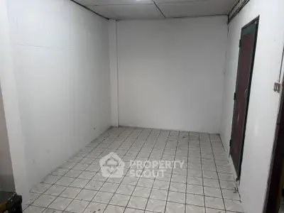 Minimalist empty room with tiled floor and white walls, ready for customization.