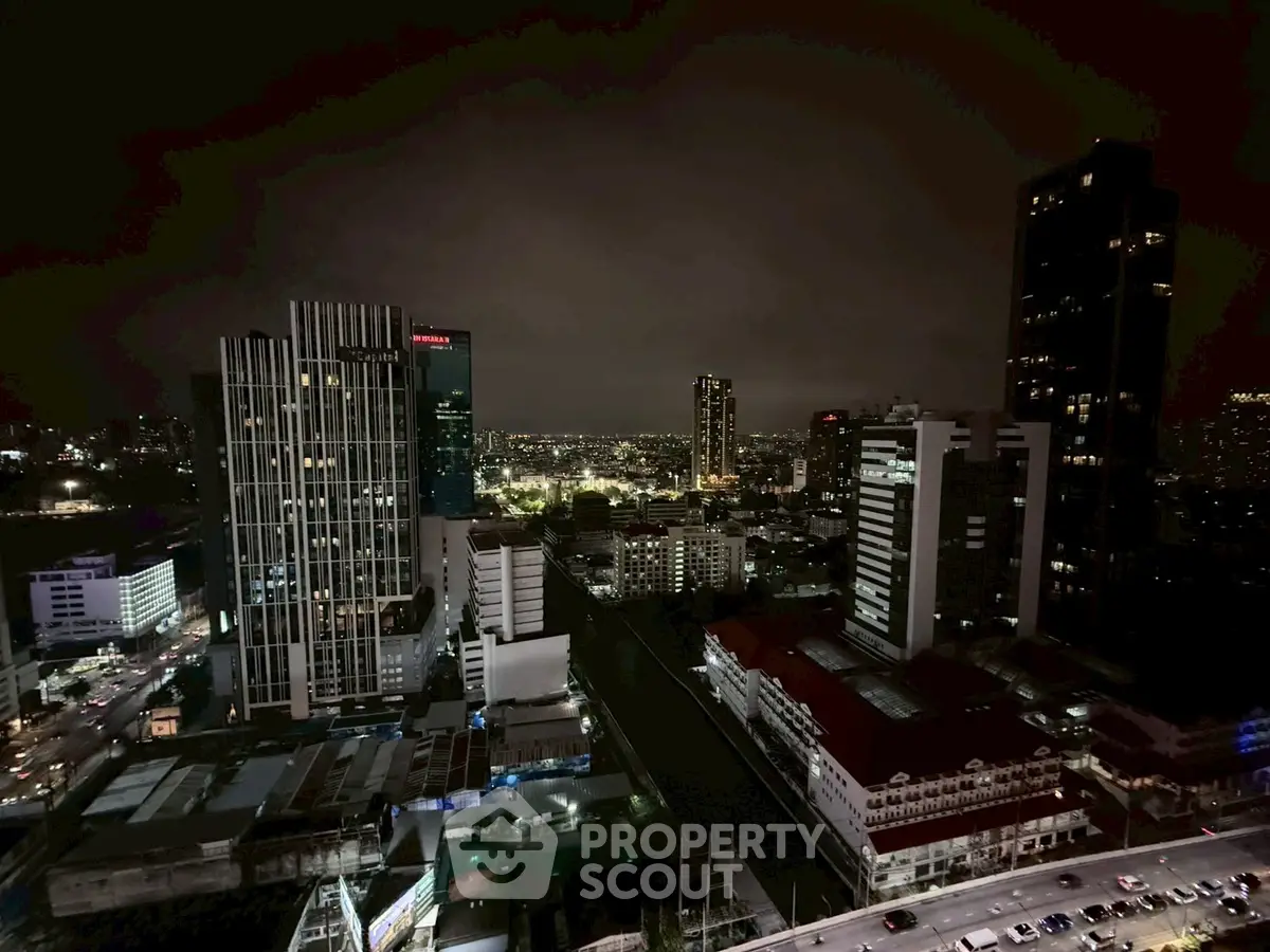 Stunning cityscape view from a high-rise building at night, showcasing urban skyline.