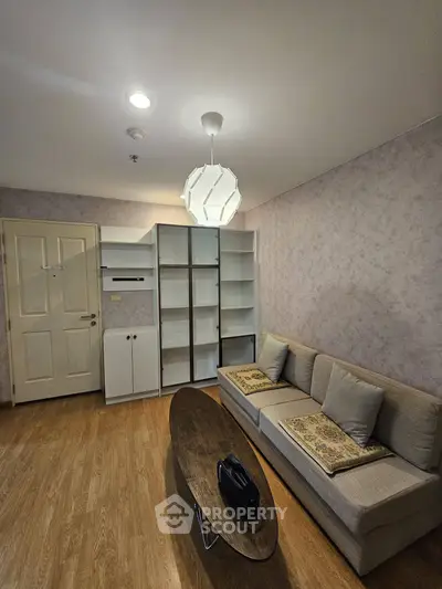 Cozy living room with modern sofa and stylish lighting in a contemporary apartment.