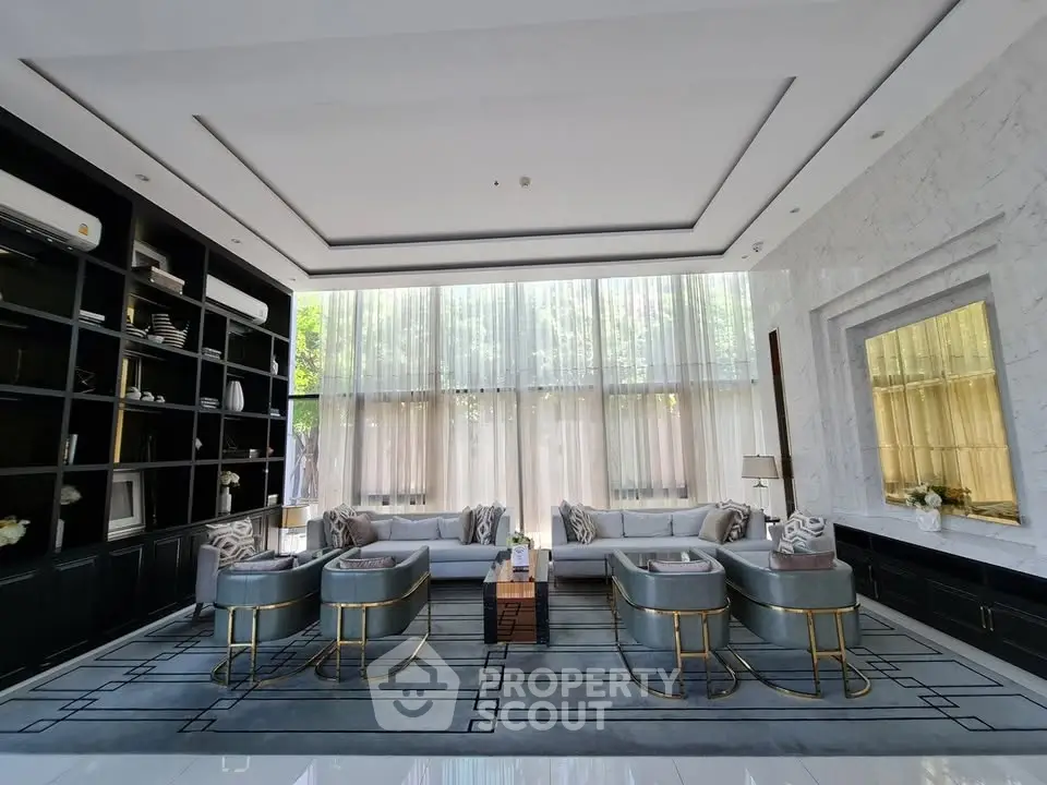 Luxurious living room with elegant decor and large windows offering natural light.